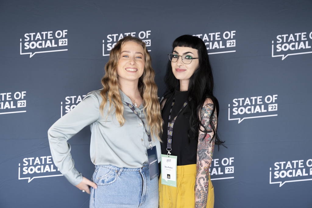 Two delegates at the SOS22 media wall